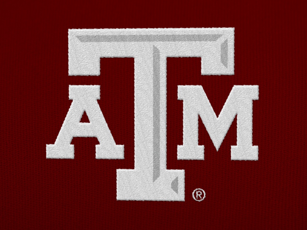 A white A&M logo embroidered on a maroon shirt
